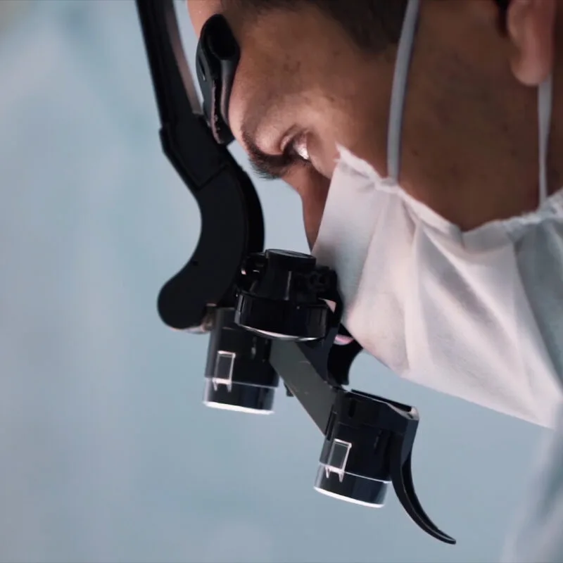 Close-up of a surgeon wearing magnifying loupes for precision during a procedure - Urgent Eye Care Doctor