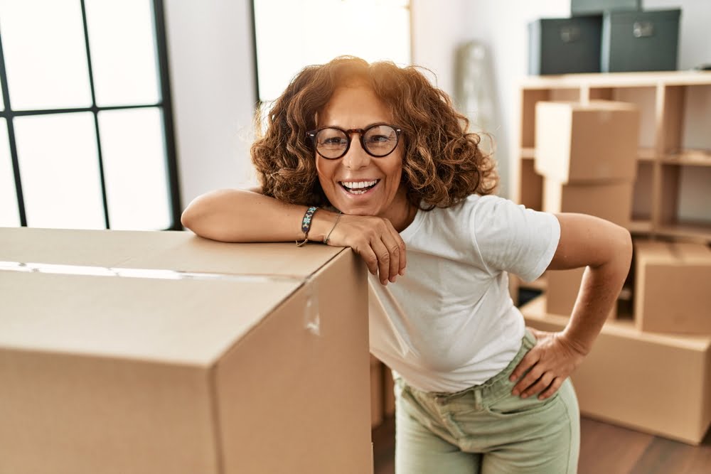 Woman with boxes wearing glasses - Diabetic Eye Exam in Costa Mesa, CA Woman with boxes wearing glasses - Diabetic Eye Exam in Costa Mesa, CA
