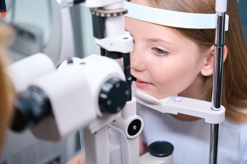 A young girl during eye exam - Pediatric Eye Exam in Costa Mesa, CA