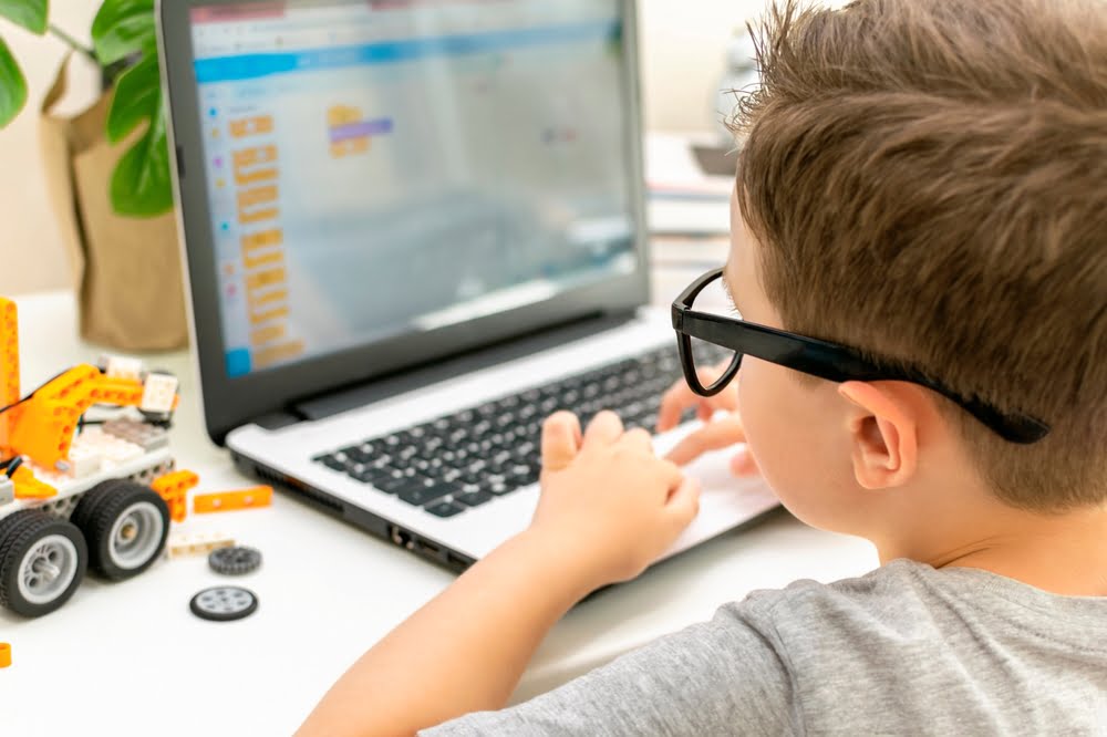 A young boy using a laptop - myopia control in Costa Mesa, CA