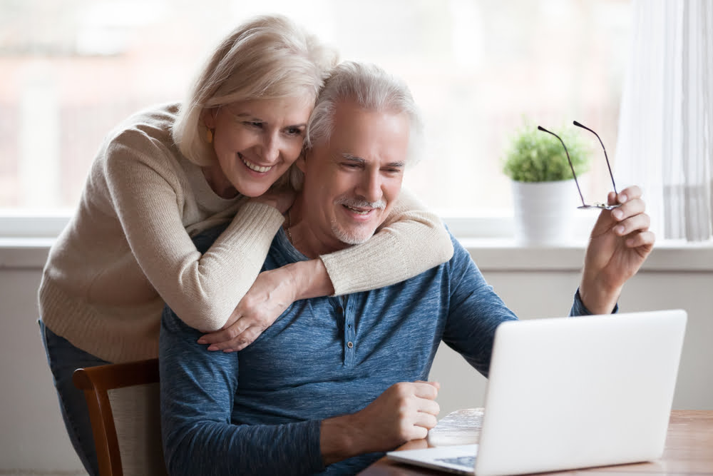 Elderly couple looking at laptop - Emergency Eye Care in Costa Mesa, CA