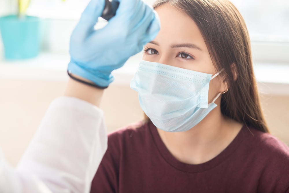 Woman wearing a facemask during an eye exam in Costa Mesa, CA Woman wearing a facemask during an eye exam in Costa Mesa, CA